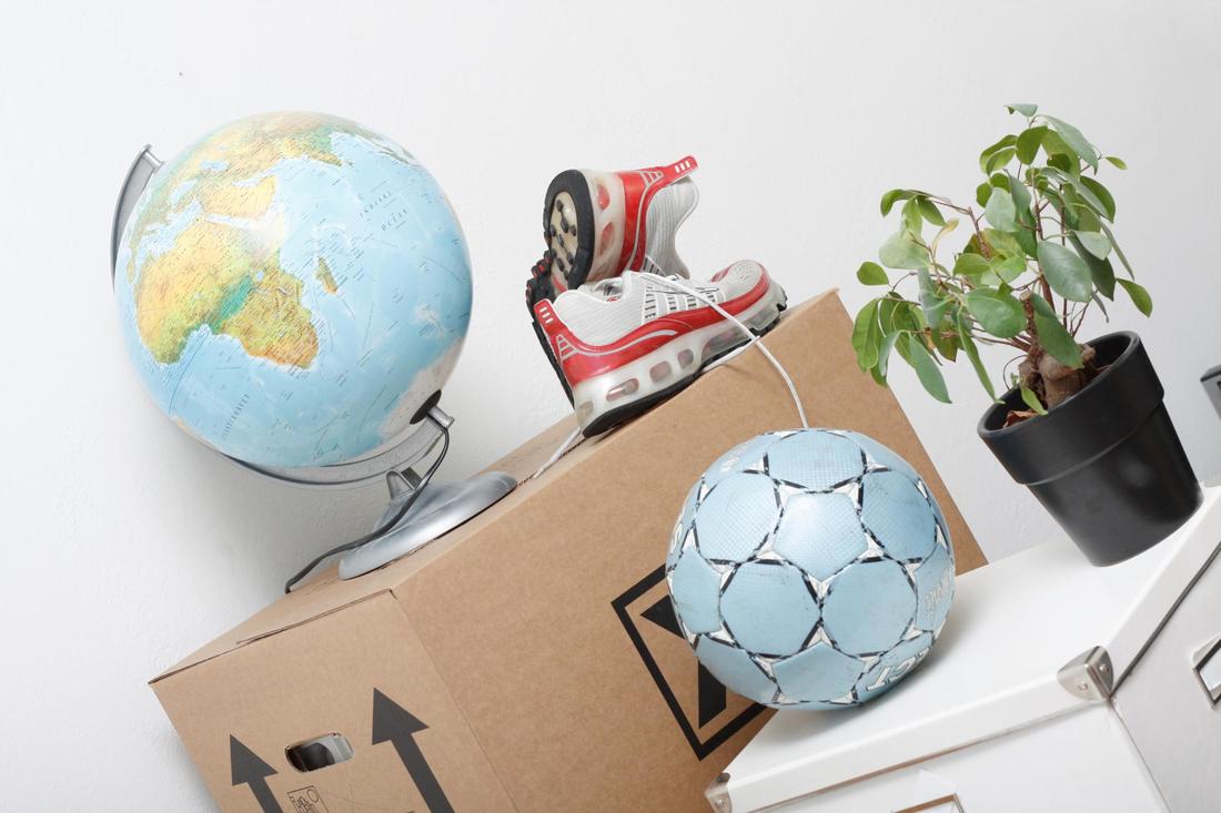 This is a picture of globe, shoes and boxes prepared for moving.